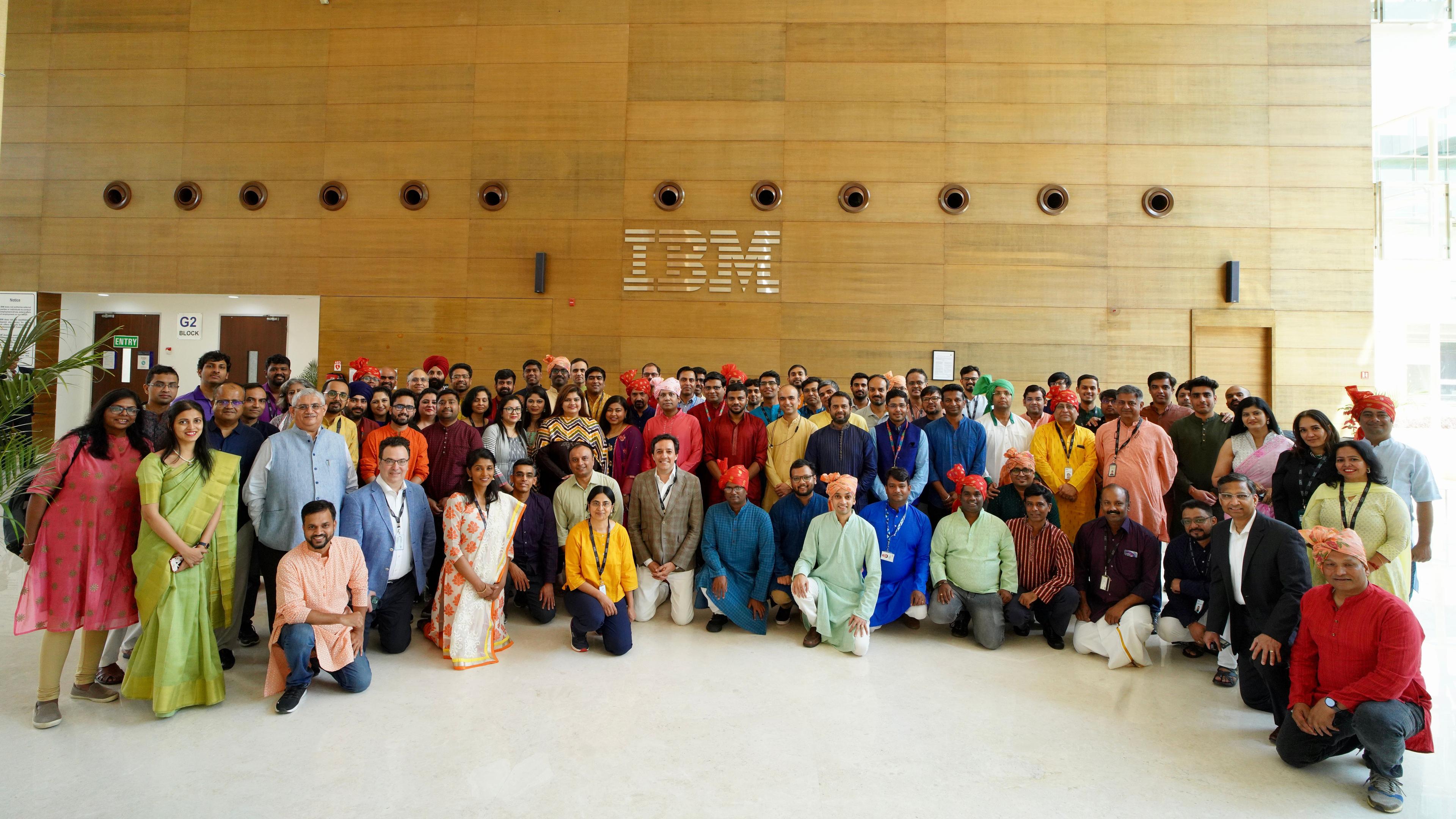 IBM Researchers in India posing in front of an IBM sign.
