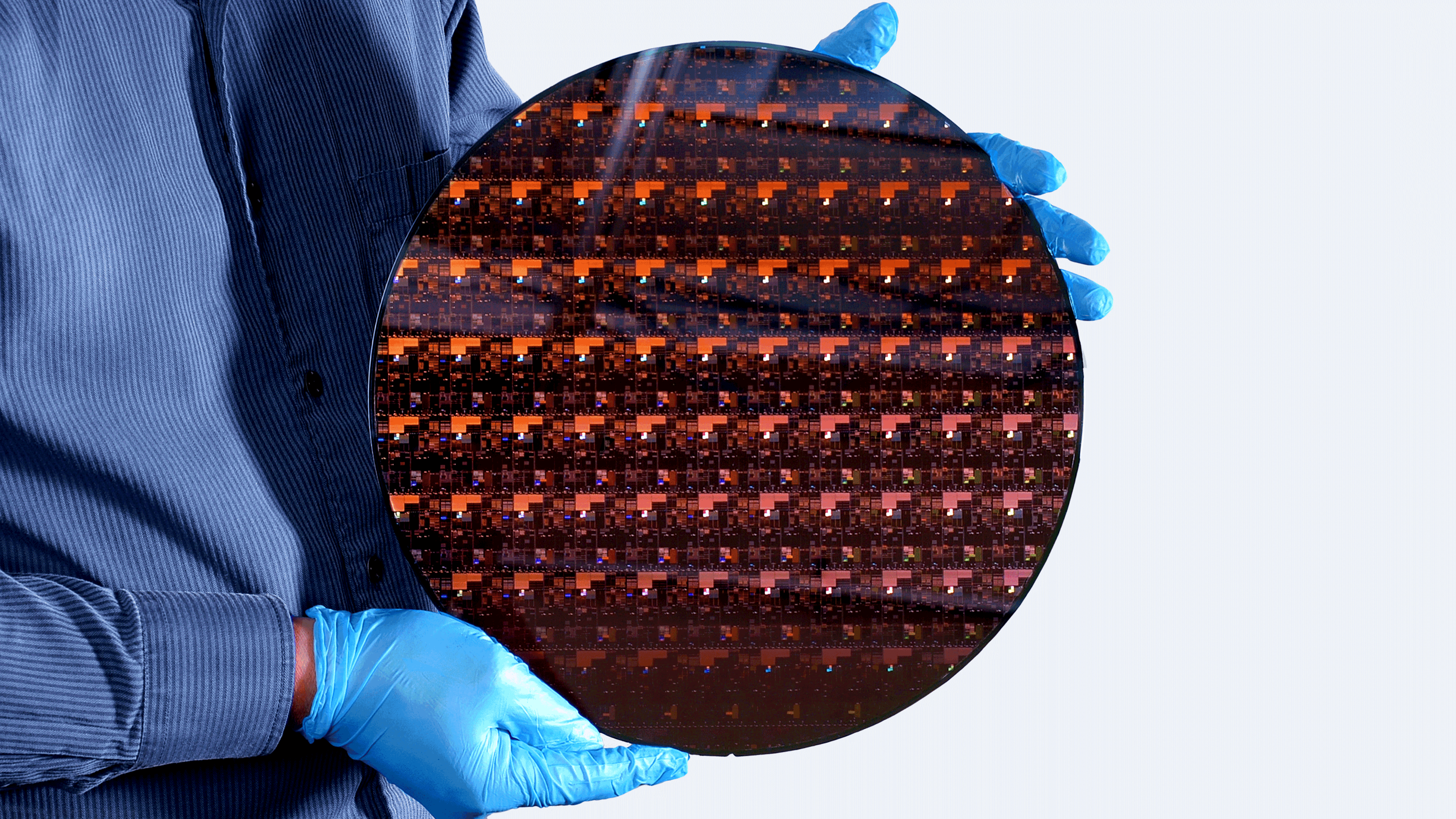 A researcher holding a 2 nm wafer