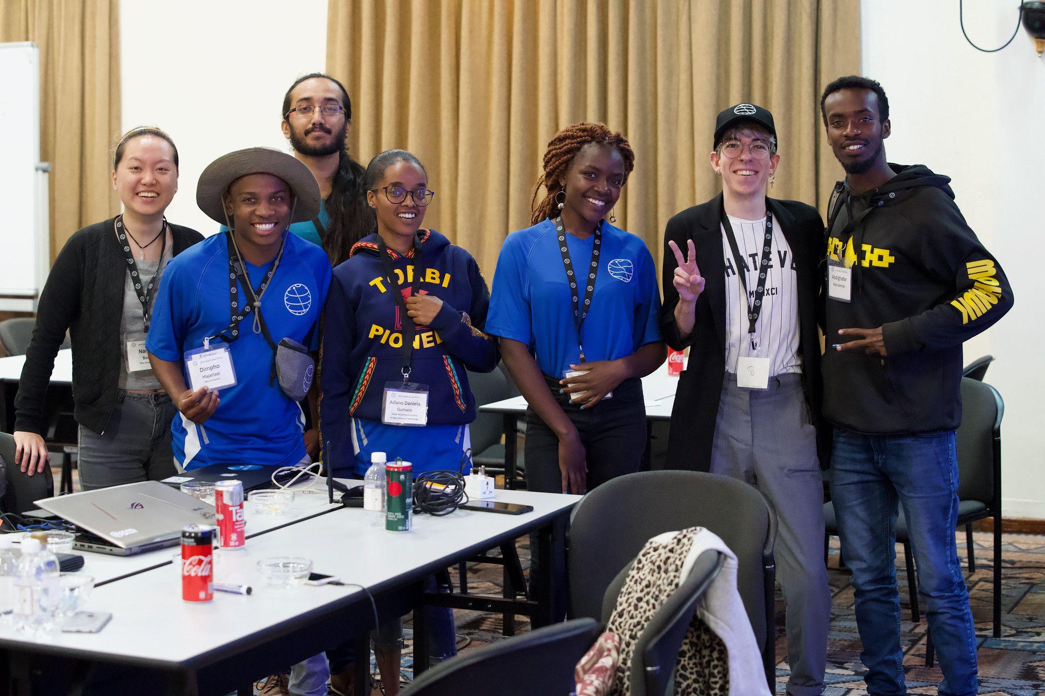 Photograph of seven attendees of Qiskit Camp 2019 smiling