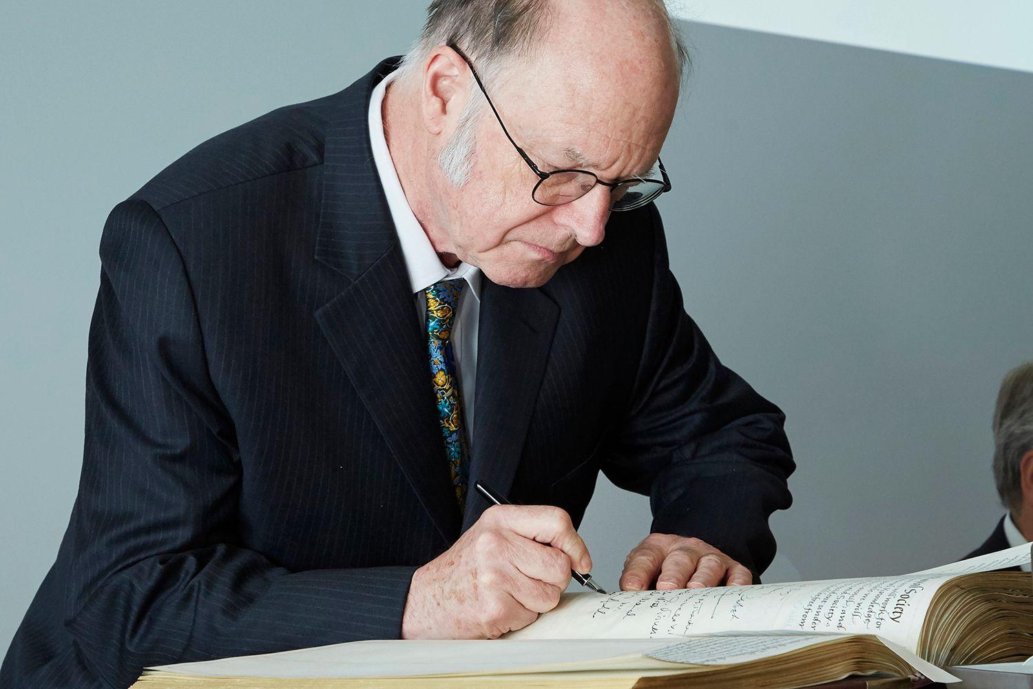 IBM Fellow Charles H. Bennett signing the Royal Society members’ book.