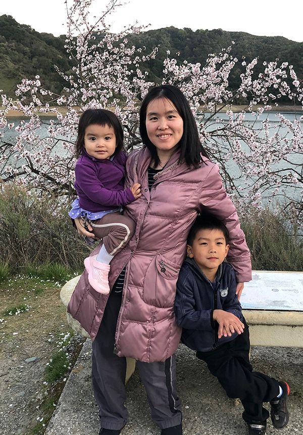 Picture of Hsinyu (Sidney) Tsai, Research Staff Member, with her children near a river.